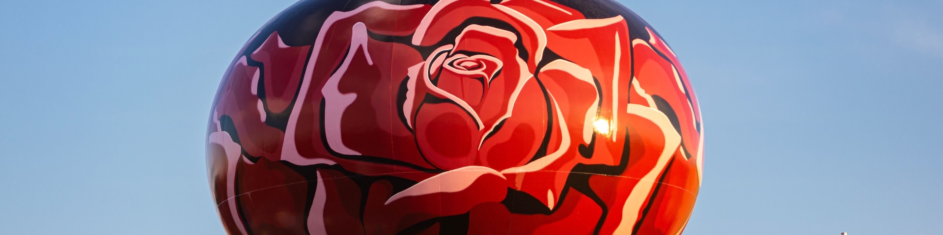 A beautiful red rose flower design on a water tower in Rosemont, Illinois.