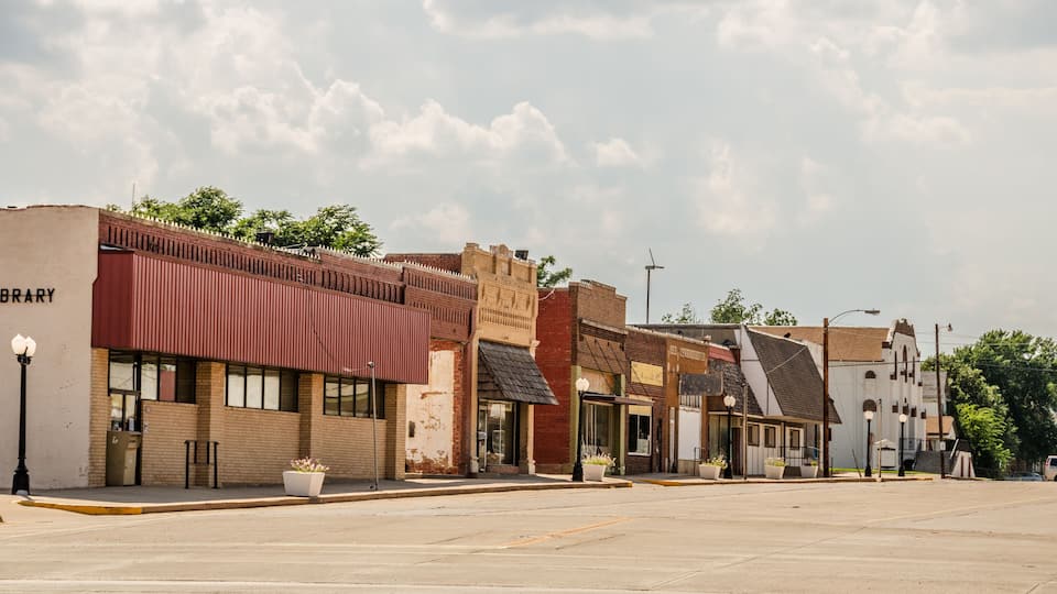 A row of historic buildings with a library on the left.