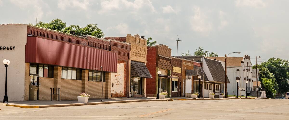 A row of historic buildings with a library on the left.