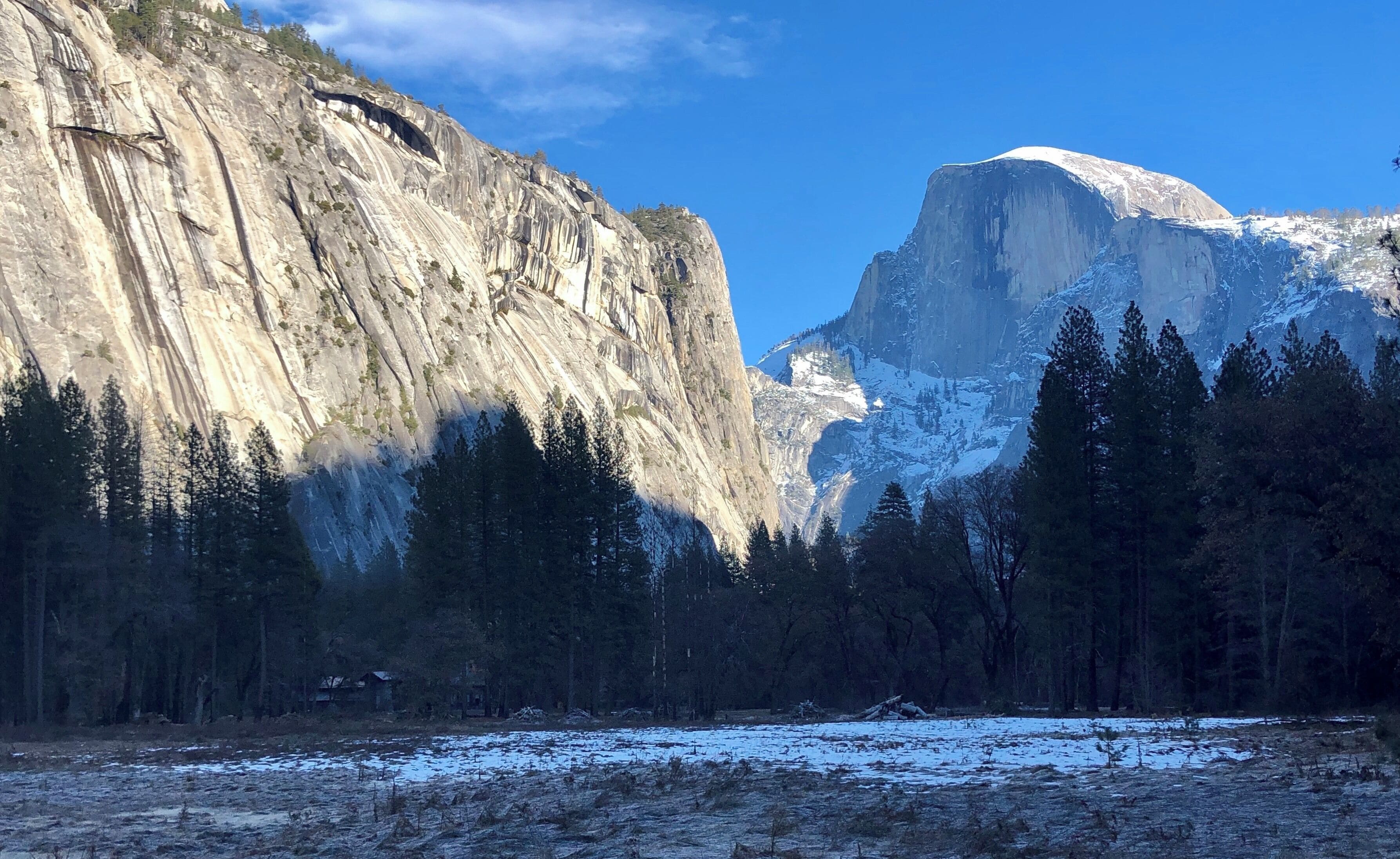 The iconic Half Dome from across a frozen meadow.