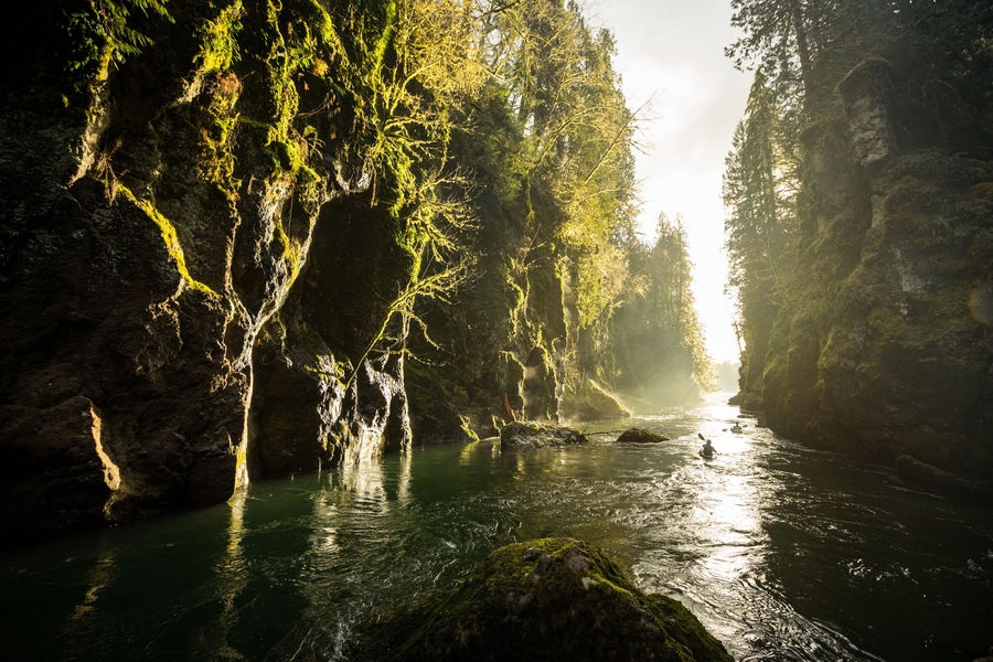 Kayakers paddle through a canyon on the Tilton River in Washington