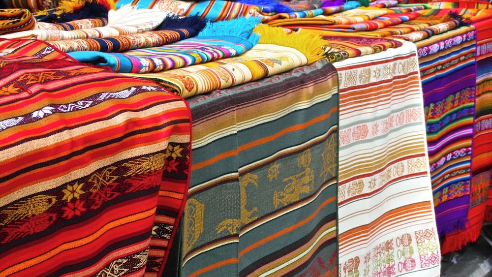 A variety of colorful textiles displayed on a table.