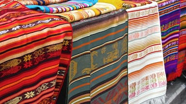 Diversos tecidos coloridos expostos sobre uma mesa.