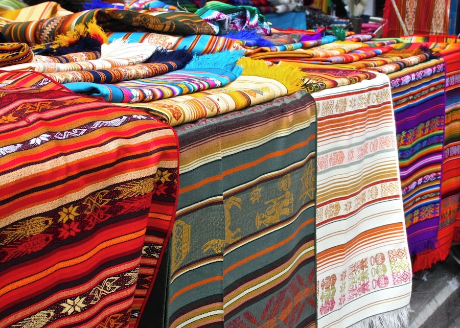 A variety of colorful textiles displayed on a table.