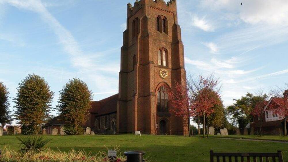 A church with a tall tower and a clock.