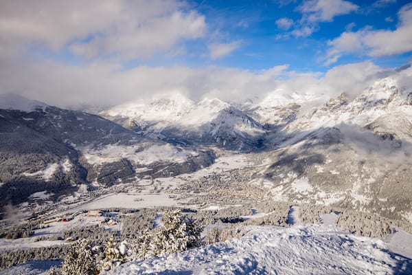 A snow-covered mountain range with a valley town.