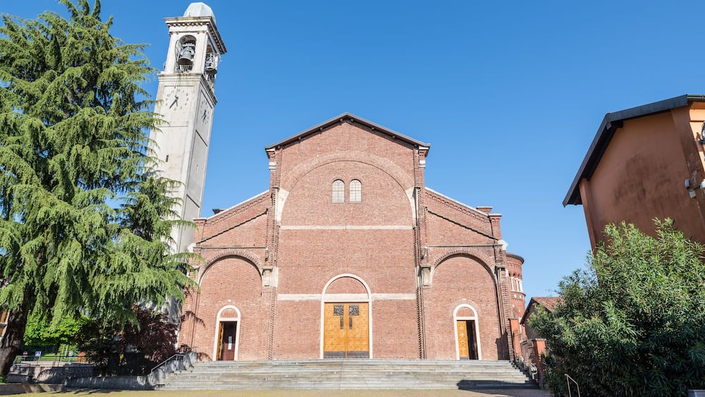 A historic church with a bell tower and a large wooden door.