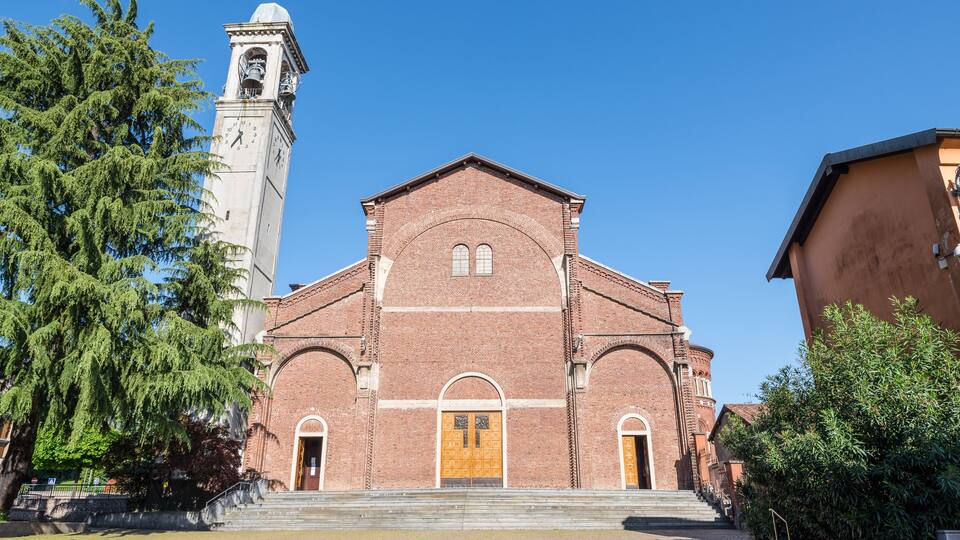 A historic church with a bell tower and a large wooden door.