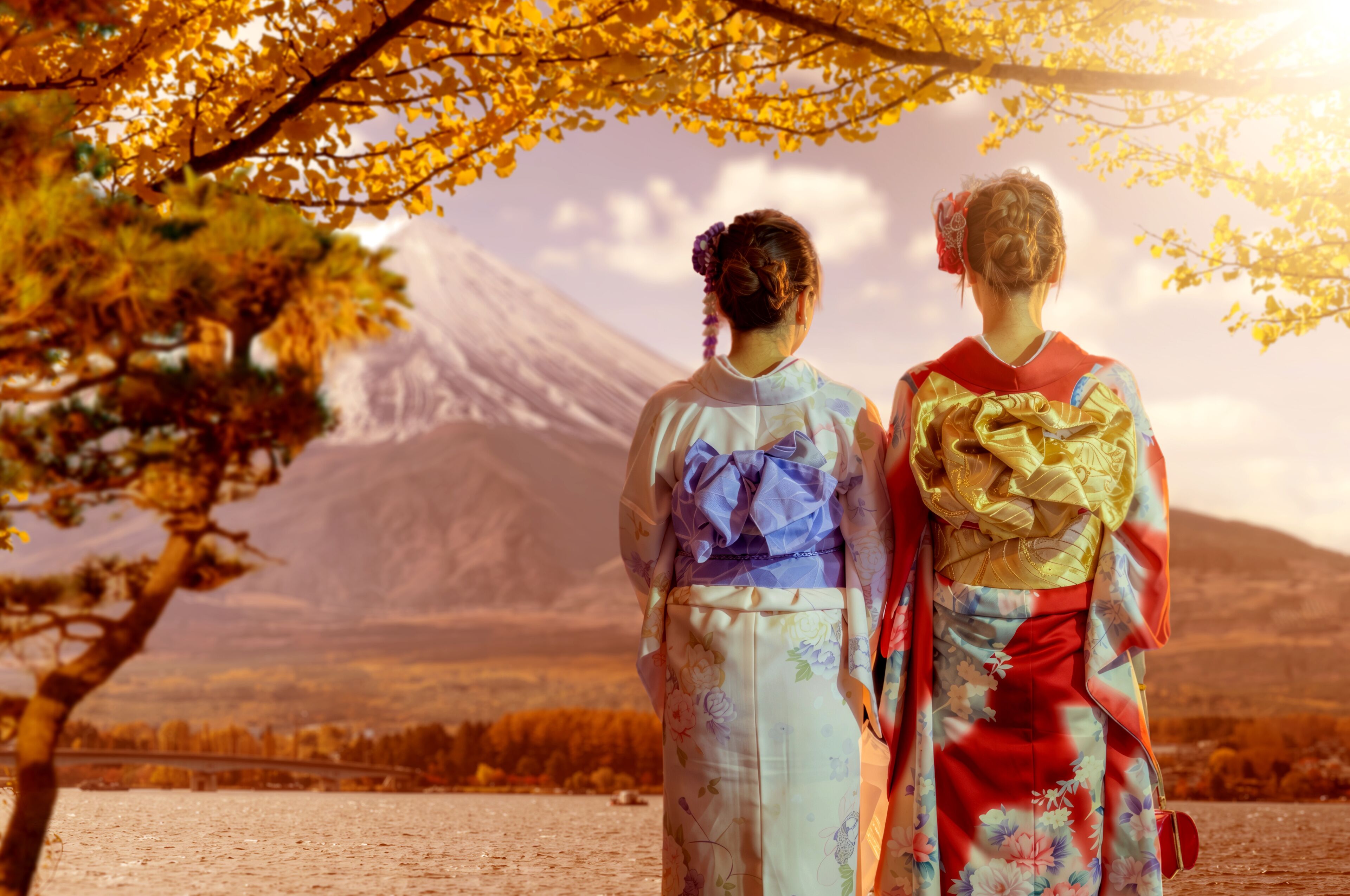 Japan travel, cultural tourism. Women in kimono admire Mount Fuji and autumn scenery during sightseeing trip and traditional holiday.