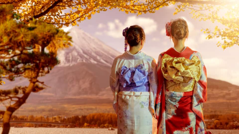 Japan travel, cultural tourism. Women in kimono admire Mount Fuji and autumn scenery during sightseeing trip and traditional holiday.