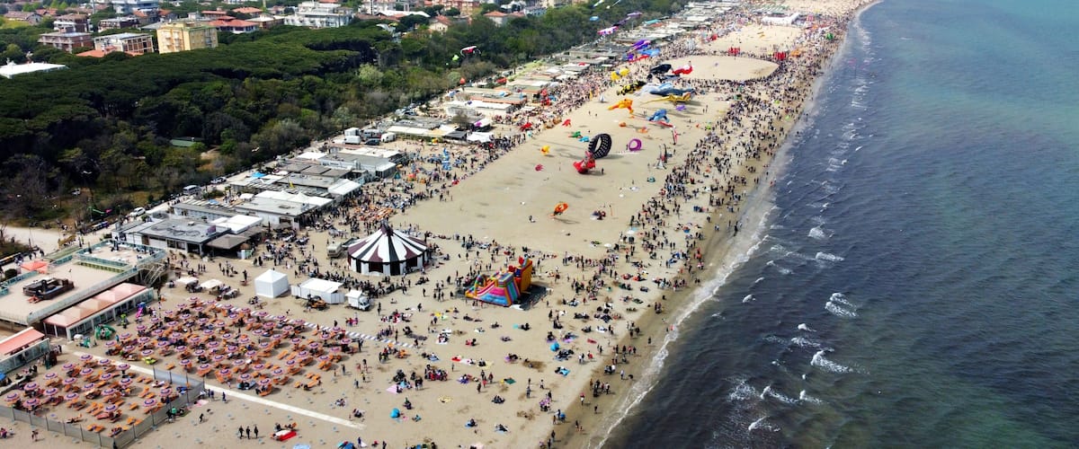 Aerial view of a gathering of kites on the beach at Pinarella di Cervia, Ravenna, Italy