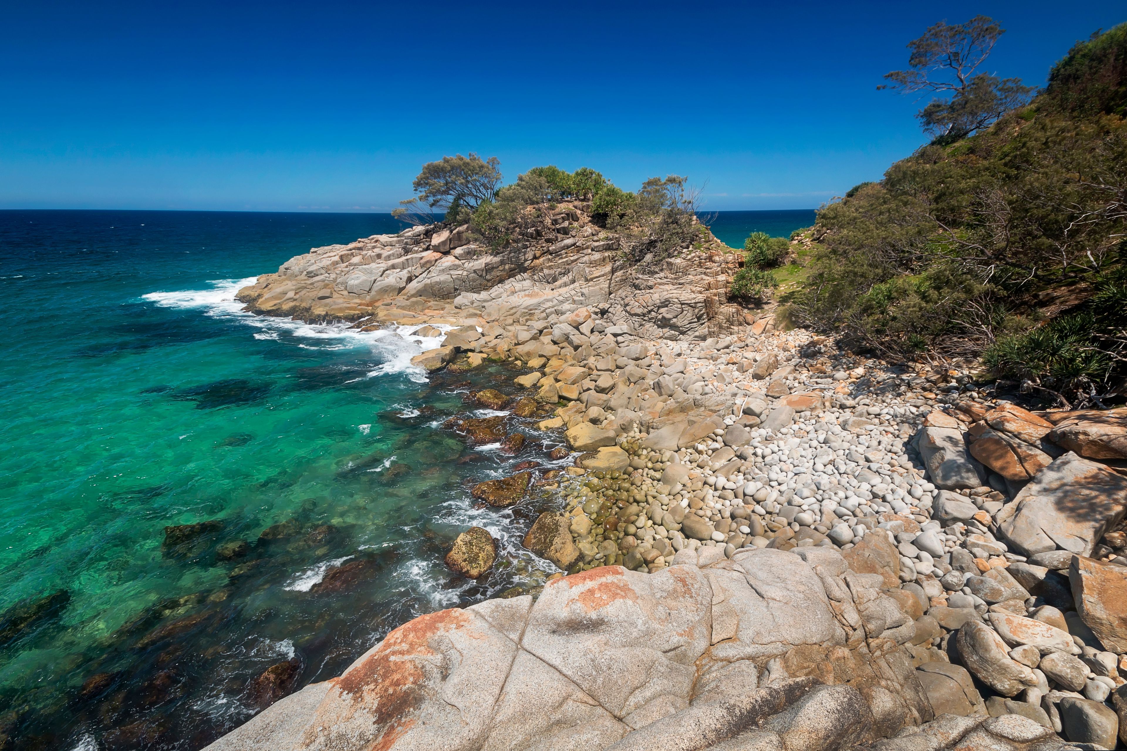 a rocky island in the middle of a body of water