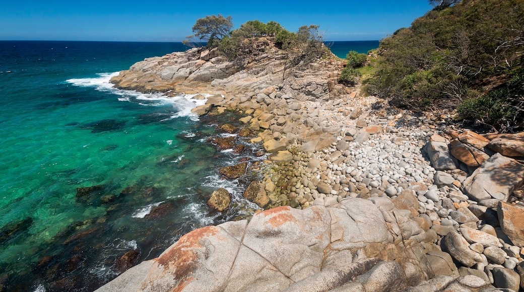 a rocky island in the middle of a body of water