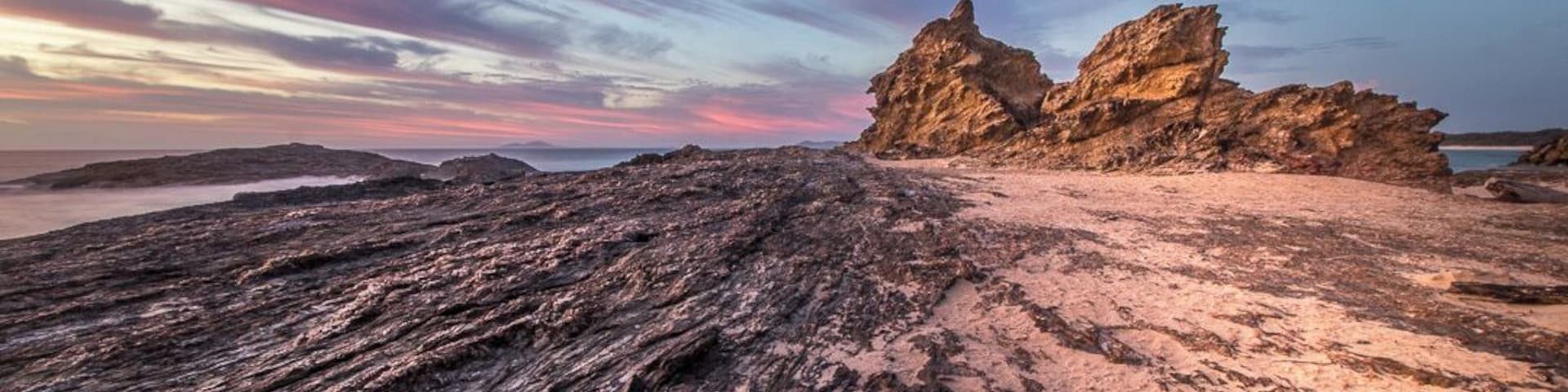 Hidden away at the far end of the breakwater V-Wall is Wellington Beach. At the Nrth Eastern end of the beach sits the spectactular Wellington Rock.