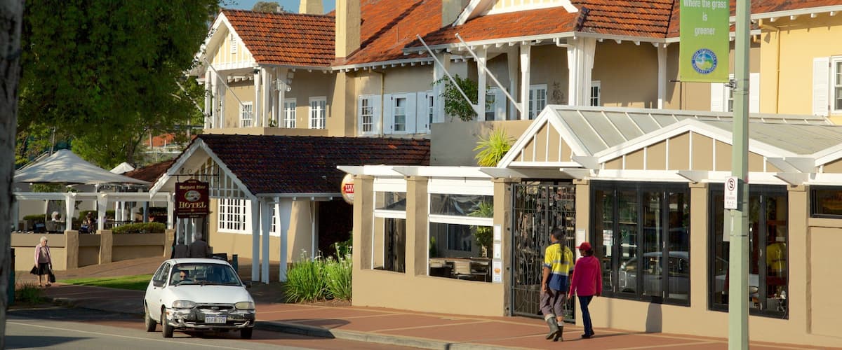A street with buildings, a car, and pedestrians.