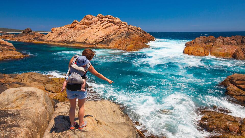 A rocky coastline with waves crashing against the rocks.