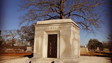 Burial site of Tyrus (Ty) Raymond Cobb in his home town of Royston, Georgia. Ty Cobb is widely regarded as one of, if not the best, baseball player of all time.
Nicknamed The Georgia Peach, Cobb was an American Major League Baseball outfielder. He was born in rural Narrows, Georgia. Cobb spent 22 seasons with the Detroit Tigers, the last six as the team's player-manager, and finished his career with the Philadelphia Athletics. In 1936 Cobb received the most votes of any player on the inaugural Baseball Hall of Fame ballot, receiving 222 out of a possible 226 votes (98.2%); no other player received a higher percentage of votes until 1992. In 1999, editors at the Sporting News ranked Ty Cobb 3rd on their list of "Baseball's 100 Greatest Players".
Cobb is widely credited with setting 90 MLB records during his career. He still holds several records as of the end of the 2016 season, including the highest career batting average .367 and most career batting titles with 12. He retained many other records for almost a half century or more, including most career hits until 1985 with 4,191, most career runs with 2,246 until 2001, most career games played (3,035) and at bats (11,434) until 1974, and the modern record for most career stolen bases (892) until 1977. He still holds the career record for stealing home (54 times) and for stealing second base, third base, and home in succession (5 times), and as the youngest player ever to compile 4,000 hits and score 2,000 runs. Cobb ranks fifth all-time in number of games played and committed 271 errors, the most by any American League (AL) outfielder.