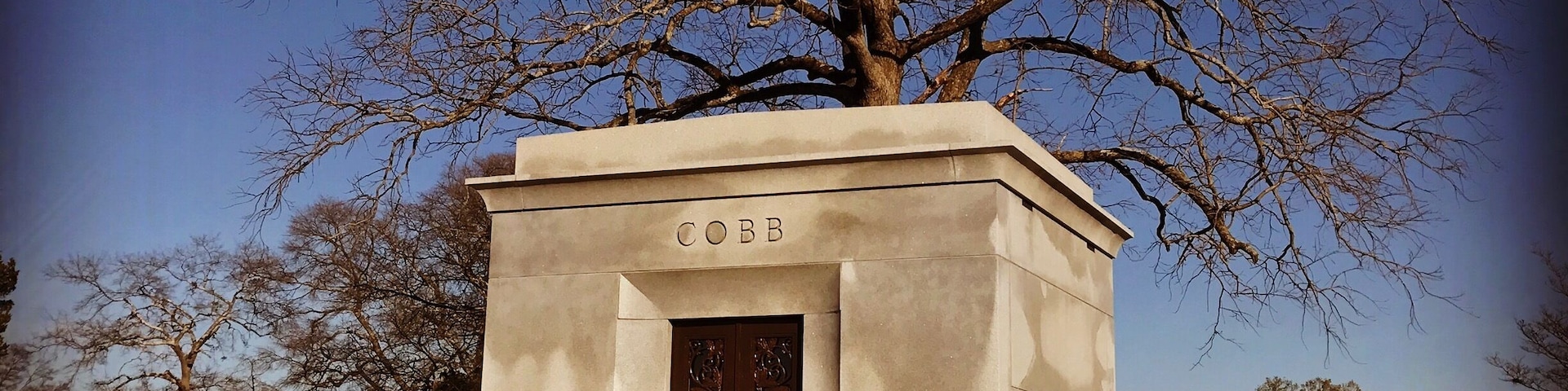 Burial site of Tyrus (Ty) Raymond Cobb in his home town of Royston, Georgia. Ty Cobb is widely regarded as one of, if not the best, baseball player of all time.
Nicknamed The Georgia Peach, Cobb was an American Major League Baseball outfielder. He was born in rural Narrows, Georgia. Cobb spent 22 seasons with the Detroit Tigers, the last six as the team's player-manager, and finished his career with the Philadelphia Athletics. In 1936 Cobb received the most votes of any player on the inaugural Baseball Hall of Fame ballot, receiving 222 out of a possible 226 votes (98.2%); no other player received a higher percentage of votes until 1992. In 1999, editors at the Sporting News ranked Ty Cobb 3rd on their list of "Baseball's 100 Greatest Players".
Cobb is widely credited with setting 90 MLB records during his career. He still holds several records as of the end of the 2016 season, including the highest career batting average .367 and most career batting titles with 12. He retained many other records for almost a half century or more, including most career hits until 1985 with 4,191, most career runs with 2,246 until 2001, most career games played (3,035) and at bats (11,434) until 1974, and the modern record for most career stolen bases (892) until 1977. He still holds the career record for stealing home (54 times) and for stealing second base, third base, and home in succession (5 times), and as the youngest player ever to compile 4,000 hits and score 2,000 runs. Cobb ranks fifth all-time in number of games played and committed 271 errors, the most by any American League (AL) outfielder.