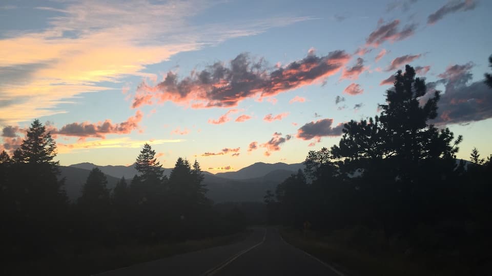 The sunsets over the mountains while driving down little cub creek road.