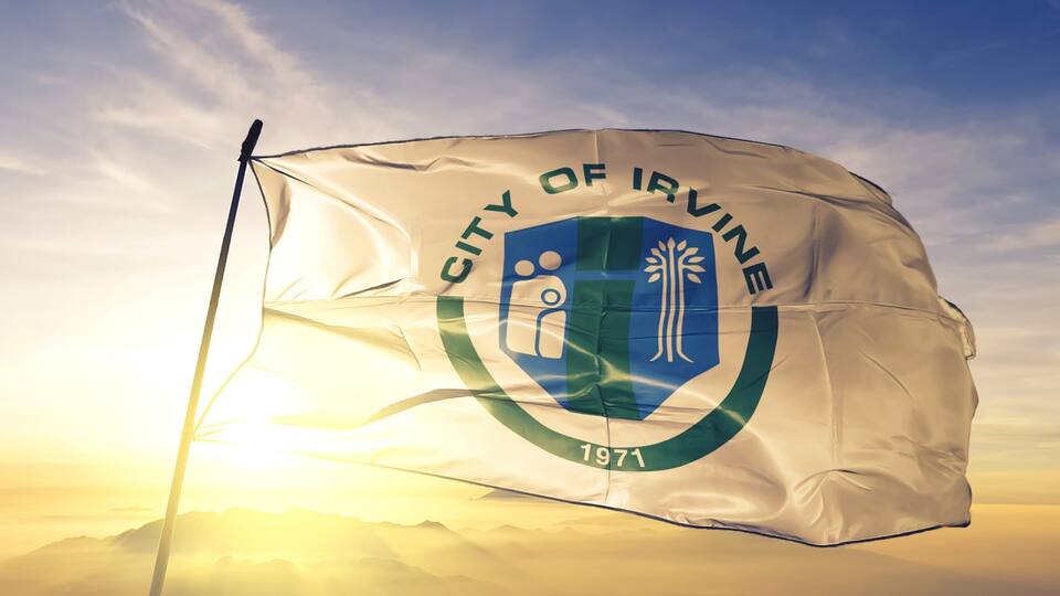 A flag of the City of Irvine with a shield emblem and the year 1971.