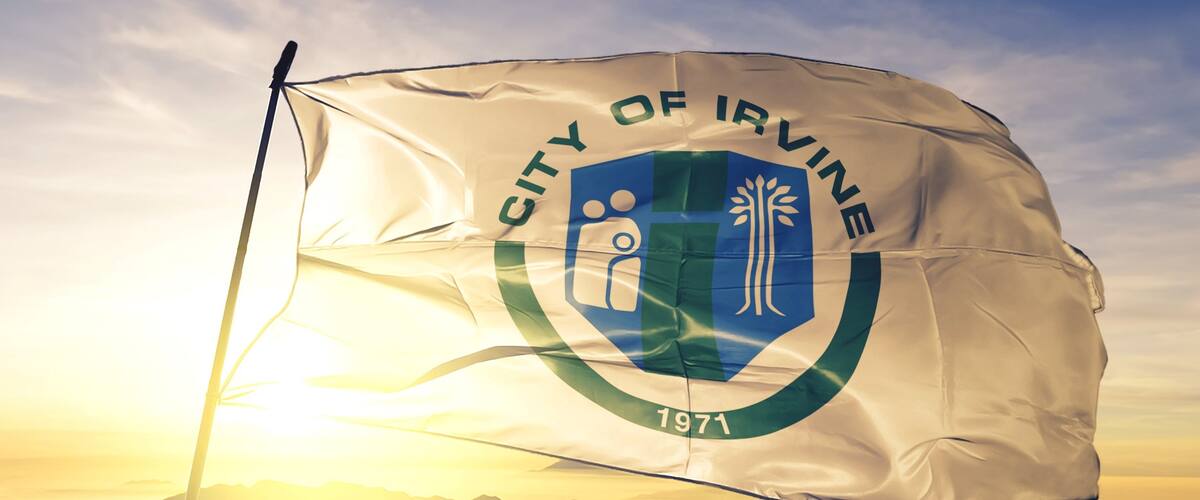 A flag of the City of Irvine with a shield emblem and the year 1971.
