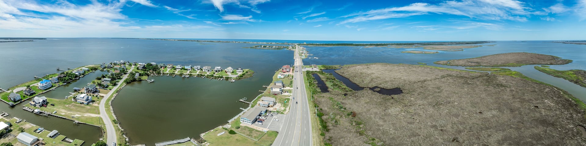Aerial view of Pond Island Outer Banks NC OBX, coastal highway connecting the outer islands to the mainland with marina, luxury vacation homes