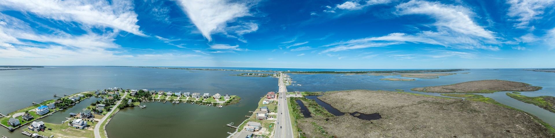 Aerial view of Pond Island Outer Banks NC OBX, coastal highway connecting the outer islands to the mainland with marina, luxury vacation homes