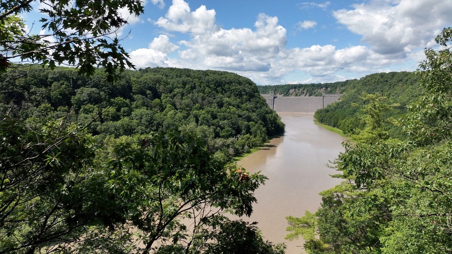 Mt Morris Dam in New York State on Genesse River at Letchworth State Park with blue sky and clouds in a beautiful countryside landscape with green trees in summer season