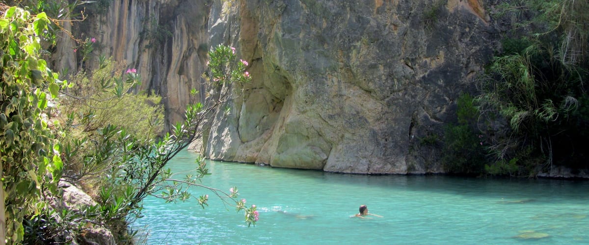 Clear blue waters and a stunning canyon surround this little river near the town of Montanejos, Spain. It is a short drive from the big town of Valencia, and was my favorite place to escape the city and the heat when I lived in Valencia. Hardly any crowds, you can swim down the calm springs to find underwater caves, mini waterfalls, and of course nearby restaurants in the town for sangria and tapas. #LiveLikeALocal