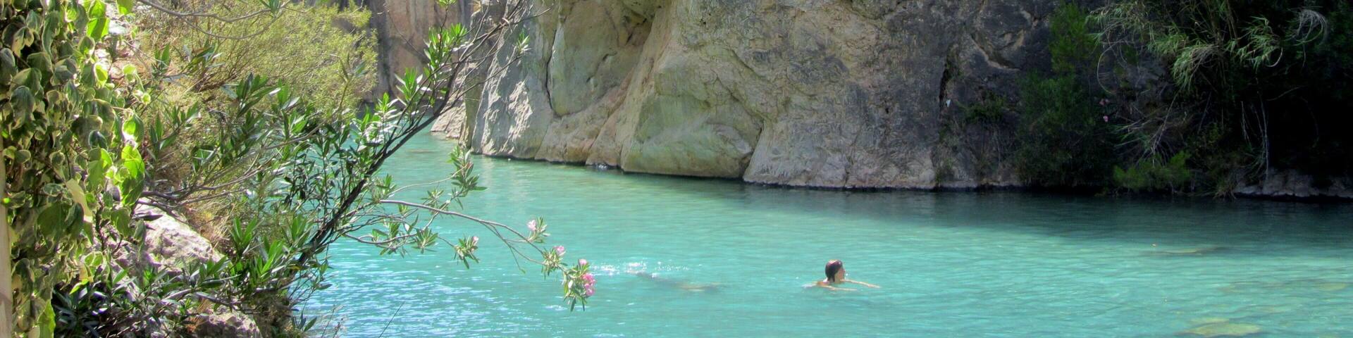 Clear blue waters and a stunning canyon surround this little river near the town of Montanejos, Spain. It is a short drive from the big town of Valencia, and was my favorite place to escape the city and the heat when I lived in Valencia. Hardly any crowds, you can swim down the calm springs to find underwater caves, mini waterfalls, and of course nearby restaurants in the town for sangria and tapas. #LiveLikeALocal
