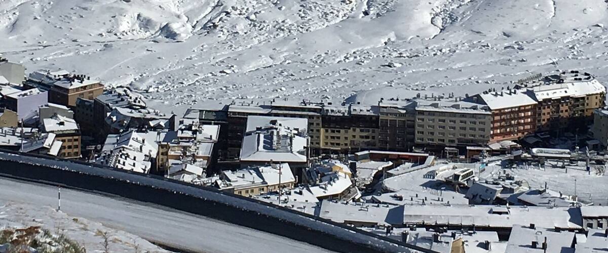 A snow-covered mountain with a town at its base.