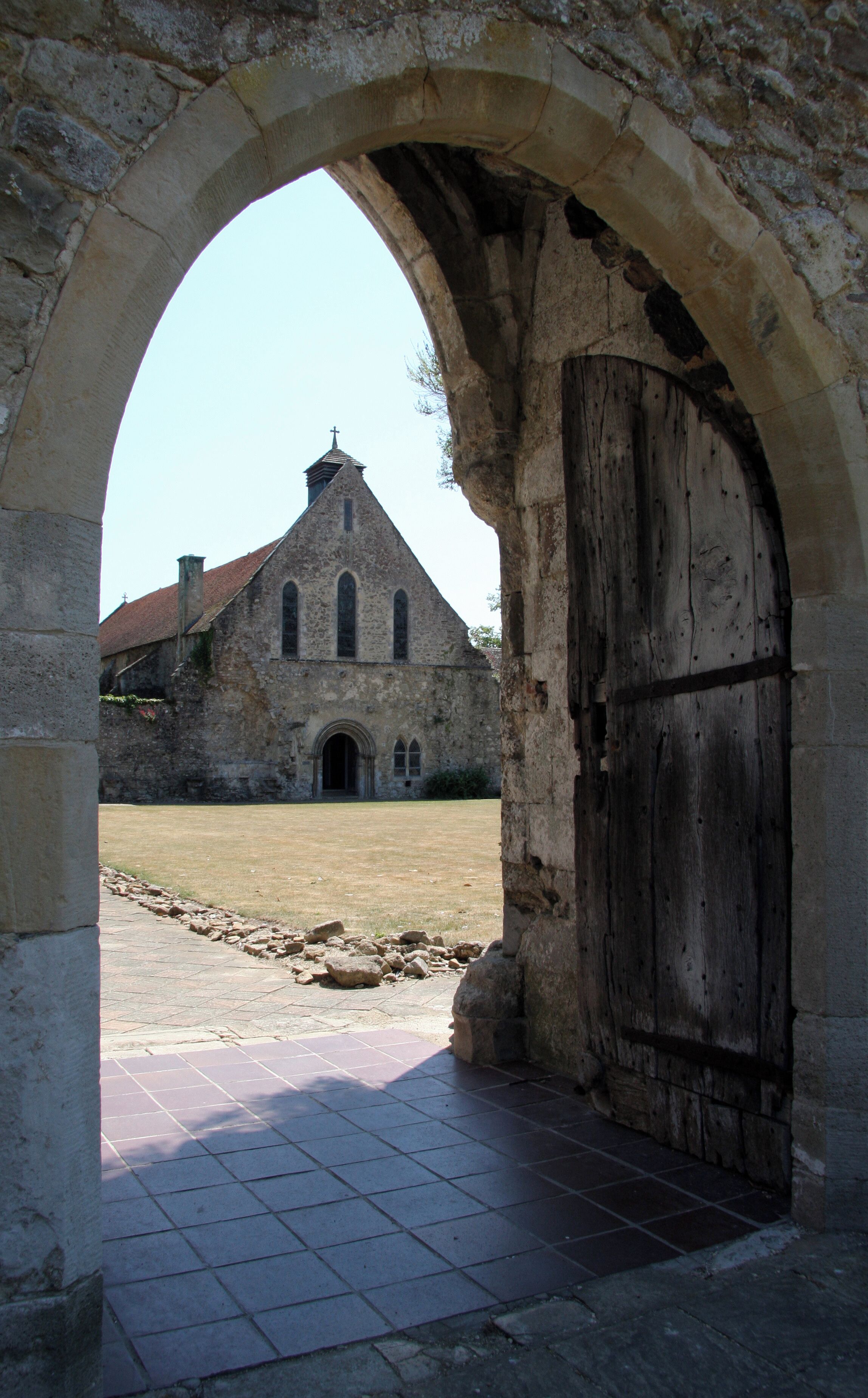 An old stone building with a large wooden door and an arched entrance.