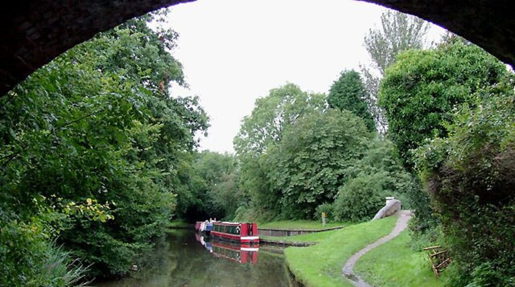 Stratford-upon-Avon Canal at Hockley Heath, Solihull. The canal is seen here from below the arch of Bridge No 25, which carries the A4300 Stratford Road from Solihull. Ahead to the right is a short canal arm which used to lead to a coal wharf. 1716384 The Stratford-upon-Avon Canal was built from King's Norton Junction (with the Worcester and Birmingham Canal) to Kingswood Junction (with the Warwick and Birmingham Canal - now Grand Union Canal) by 1803. A second phase of construction started in 1812, and by 1815 was connected to the River Avon in Stratford. Total length 25.5 miles, with 54 locks.