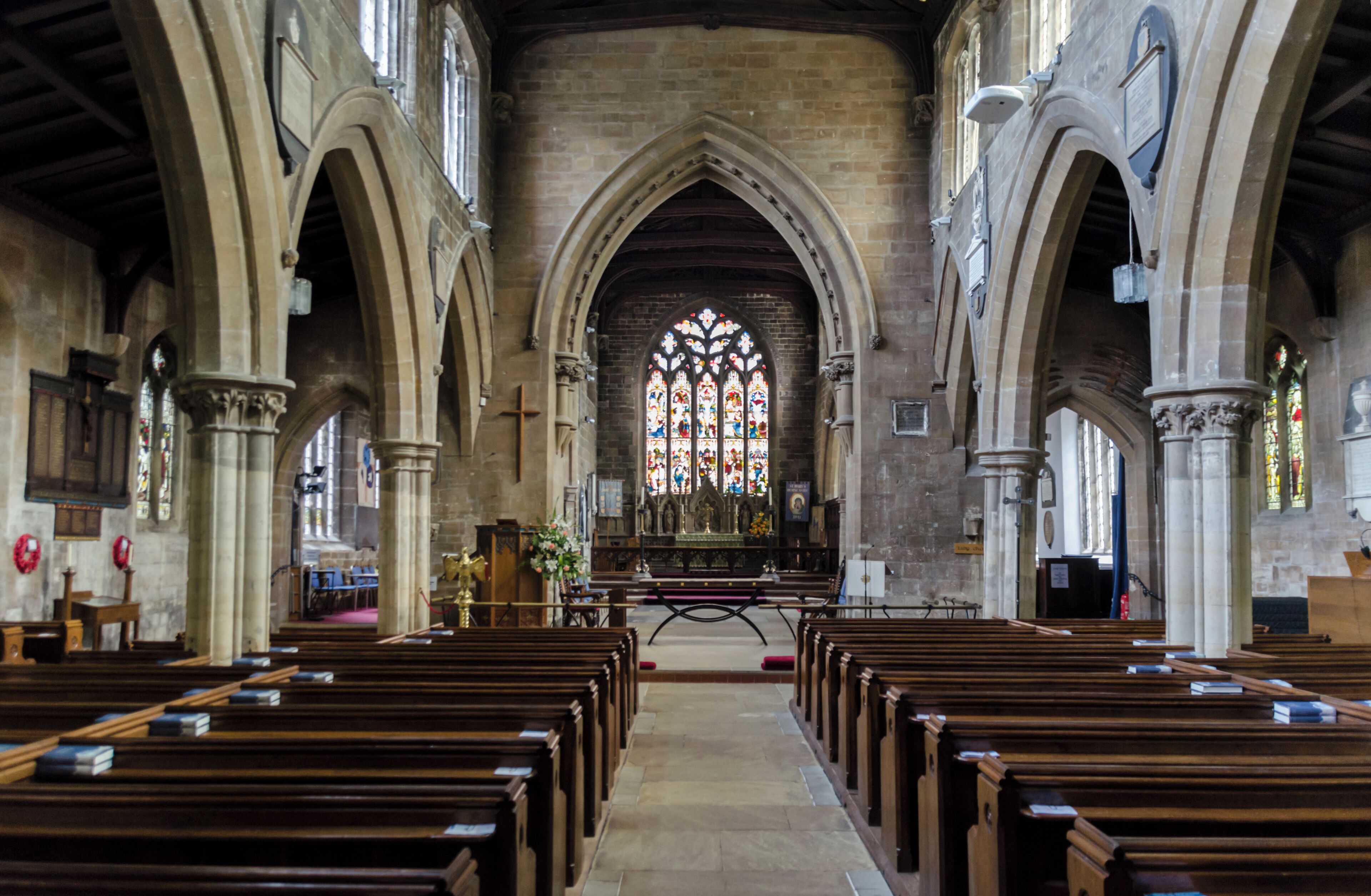 The church dates from the early 13th century onwards, and was restored in 1859-61 by Ewan Christian. It is built in green sandstone and has a west tower with spirelet, nave with north and south aisles, chancel with north and south aisles, north porch and vestry. The tower dates from circa 1200, and was remodelled in 1861. The upper part is from the decorated period. The nave arcades are of five bays and date from the early 13th century. These were restored in 1861. The chancel has 15th century arcades, two to the north and three south, again heavily restored. The chancel arch dates from the Victorian restoration. The reredos also dates from this time, and is by C. E. Giles. There is a Memorial brass to Sir Lionel Dymoke, died 1519, he was knighted at Siege of Tournai, and was Sheriff of Lincolnshire 1516. On the wall of the south aisle are mounted 13 scythes, which were thought to have been used in the Lincolnshire rising of 1536, although this is unlikely , despite Horncastle being one of the centres of the rebellion. There are several stained-glass windows, with some by Heaton Butler and Bayne, and one by Preedy. The church pipe organ was recently replaced with a new digital version. The freed up space has been converted into a Coffee area.