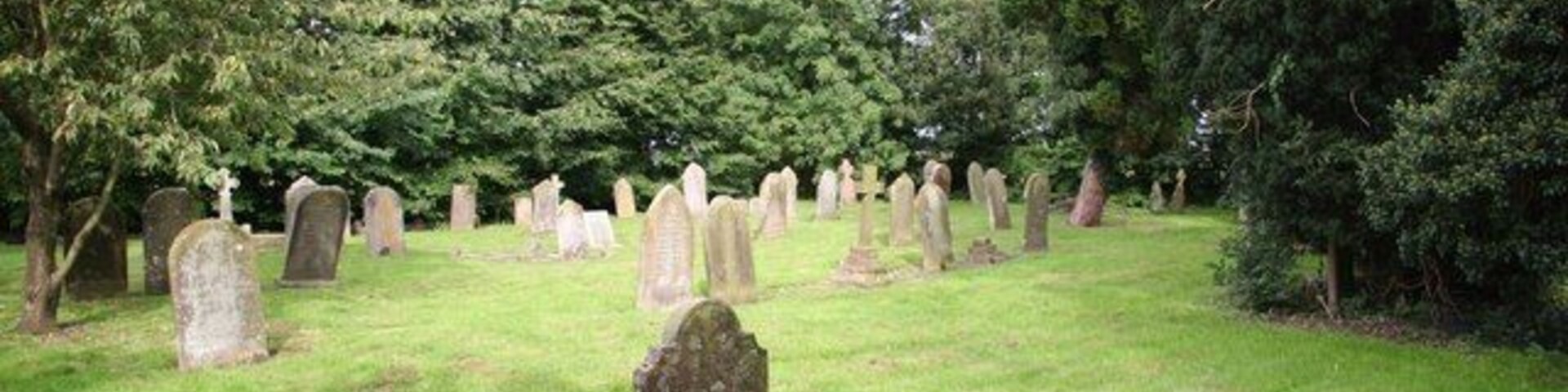 All Saints' churchyard Well tended churchyard at West Ashby