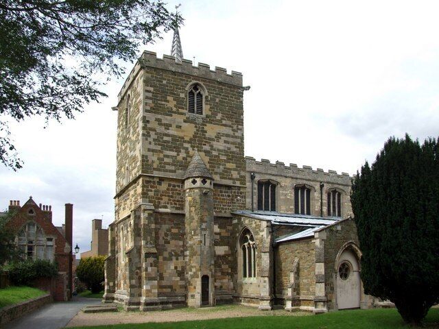 A historic stone church with a prominent tower and arched windows.