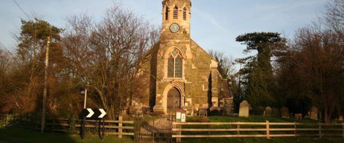 A church with a tall steeple and a clock.