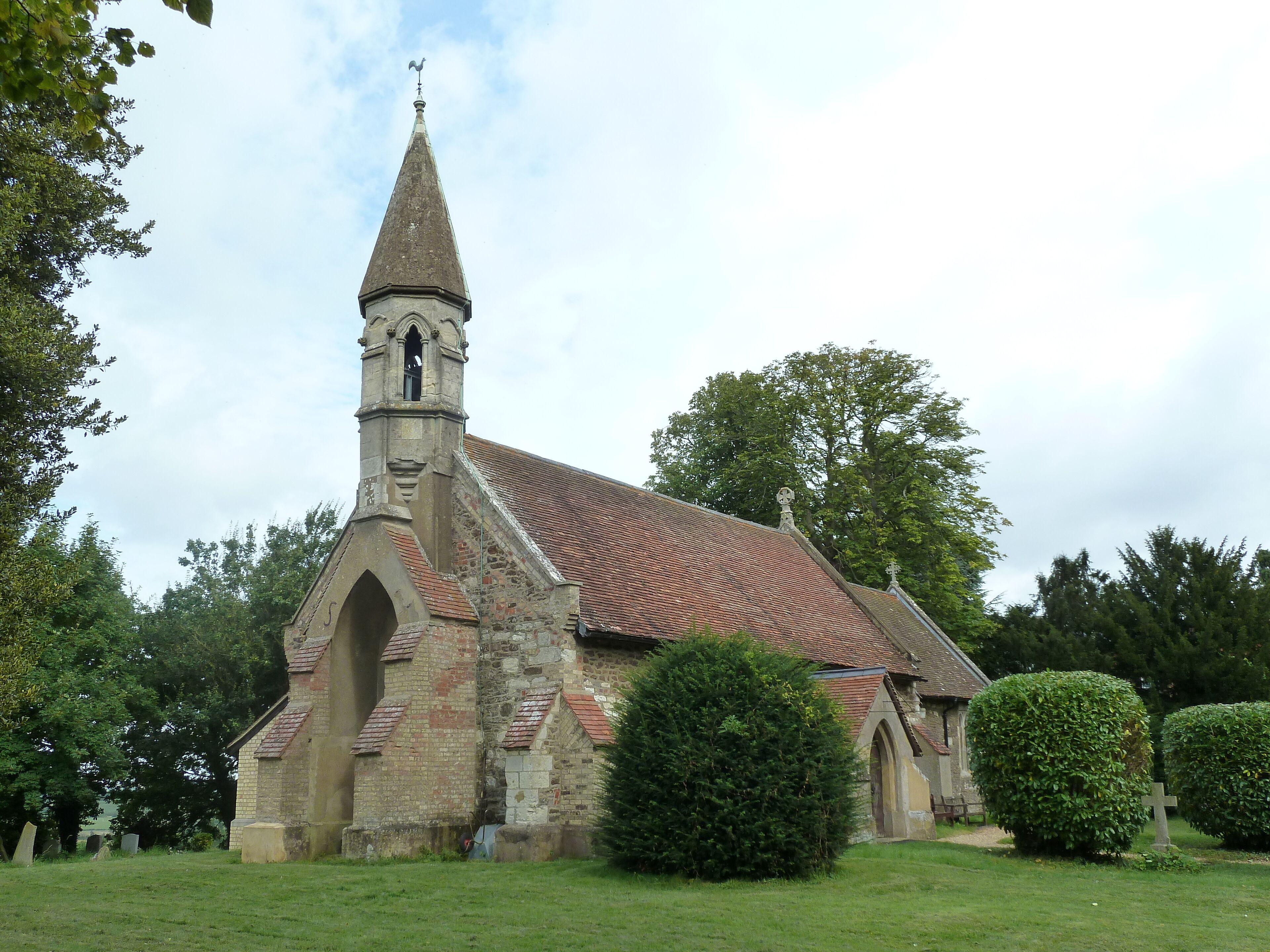 A church with a tall steeple and a clock tower.