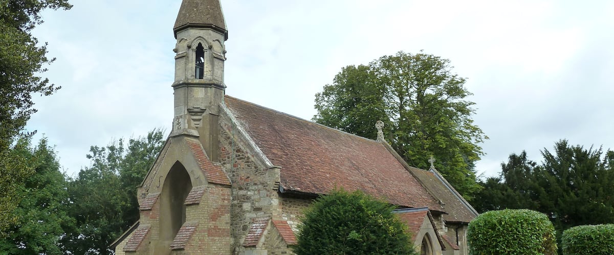 A church with a tall steeple and a clock tower.