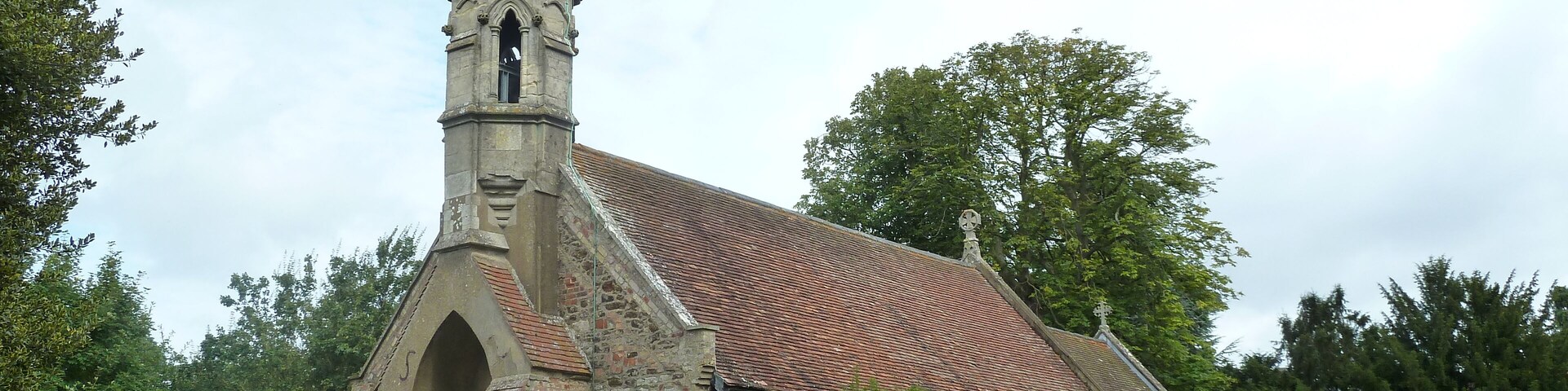 A church with a tall steeple and a clock tower.