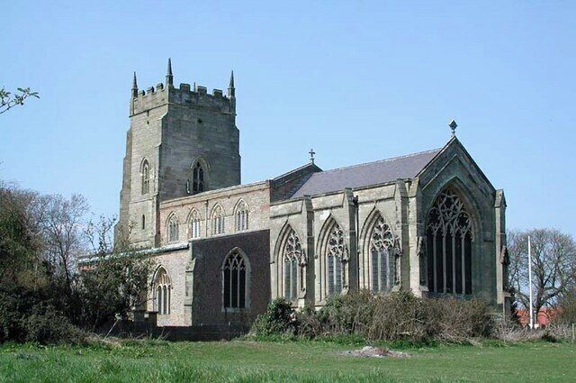 A historic church with a tall tower and Gothic architecture.
