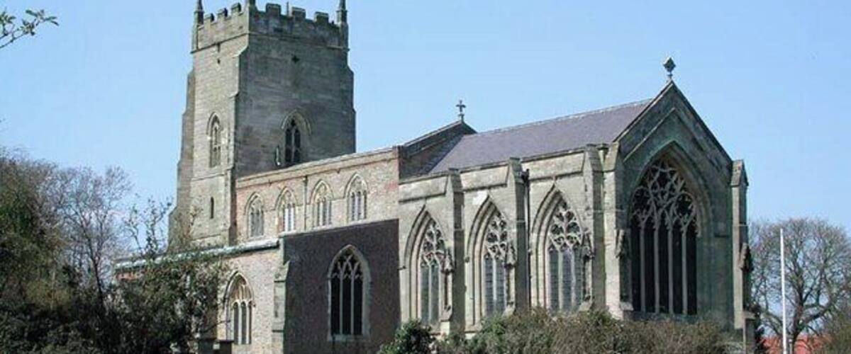 A historic church with a tall tower and Gothic architecture.