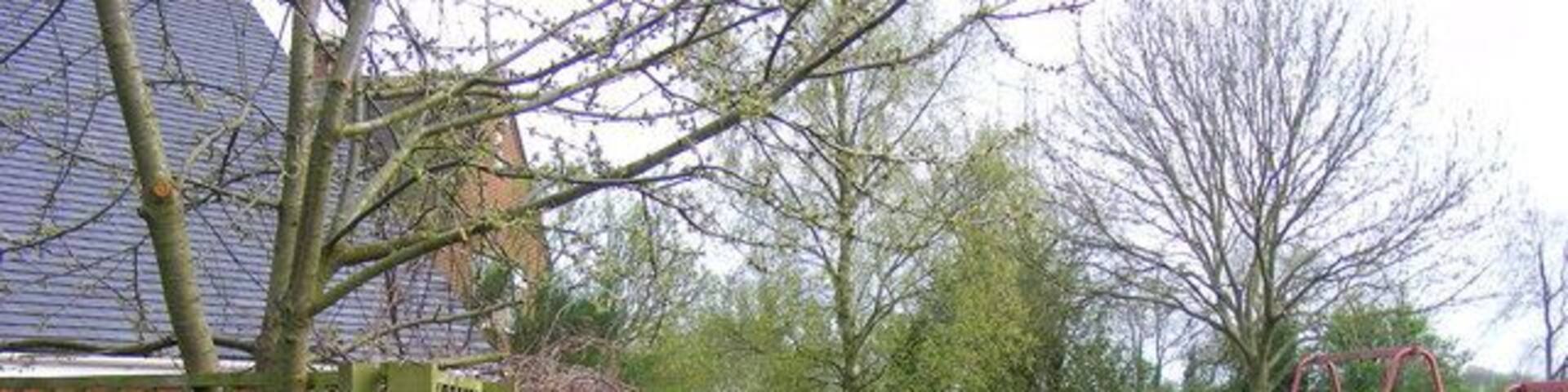 Footpath through playground A stile in the far fence shows the top end of a footpath that follows a ribbon wood all the way down to Swinford Corner.