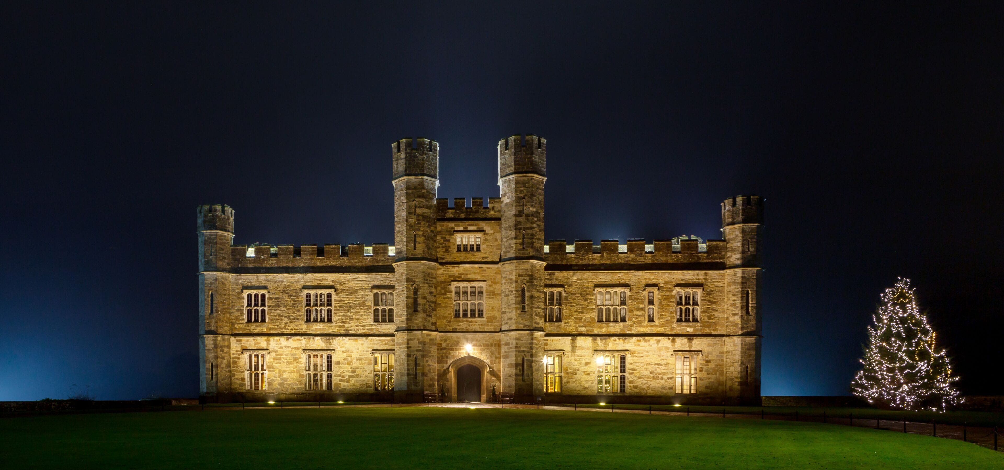 English castle with Christmas lights at night