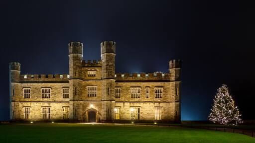 English castle with Christmas lights at night