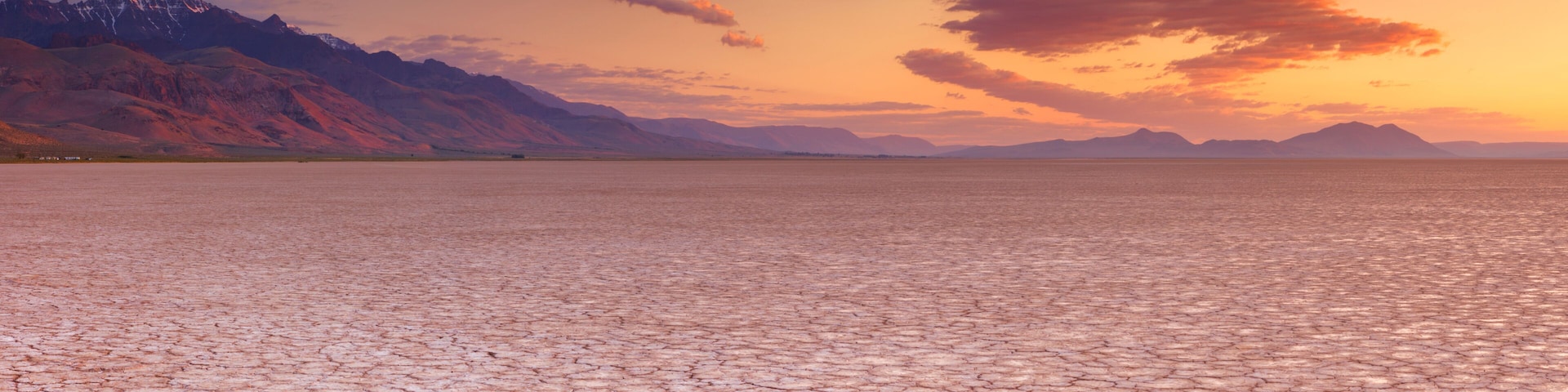 Cracked earth in remote Alvord Desert, Oregon, USA at sunrise