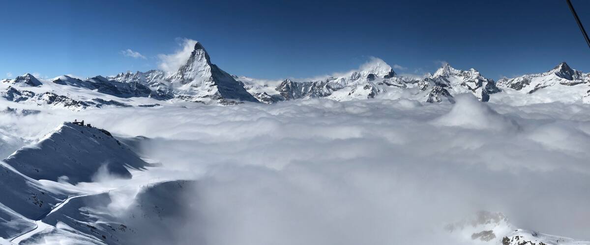 panorama view Zermatt Matterhorn gornergrat emerging from sea of clouds fog perfect sky