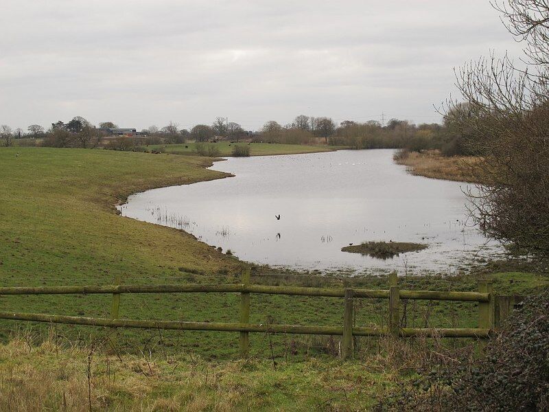 Crabmill Flash I did not think I had visited this square before but it turns out I had, nearly ten years earlier: SJ7160 : Farm machinery. See also SJ7160 : Sandbach Flashes: Crabmill Flash for the flash. Cheshire flashes The historic salt industry in south Cheshire began as the small-scale exploitation of natural brine springs and eventually led to industrial scale brine pumping. The paractice was particularly common from the 1920s to 1970s in the area around Middlewich and Sandbach, where brine was pumped out of disused salt mine workings. This led to the eventual collapse of the large underground chambers. The resulting subsidence at ground level formed water-filled depressions known as "flashes", which attract wading birds more often found in coastal saltmarshes and the like. The phenomenon (without the saline water) is also found in coal mining areas: see the similar Shared Description for Wigan Flashes. For a fuller explanation and maps, see LinkExternal link