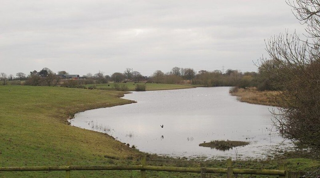 Crabmill Flash I did not think I had visited this square before but it turns out I had, nearly ten years earlier: SJ7160 : Farm machinery. See also SJ7160 : Sandbach Flashes: Crabmill Flash for the flash. Cheshire flashes The historic salt industry in south Cheshire began as the small-scale exploitation of natural brine springs and eventually led to industrial scale brine pumping. The paractice was particularly common from the 1920s to 1970s in the area around Middlewich and Sandbach, where brine was pumped out of disused salt mine workings. This led to the eventual collapse of the large underground chambers. The resulting subsidence at ground level formed water-filled depressions known as "flashes", which attract wading birds more often found in coastal saltmarshes and the like. The phenomenon (without the saline water) is also found in coal mining areas: see the similar Shared Description for Wigan Flashes. For a fuller explanation and maps, see LinkExternal link