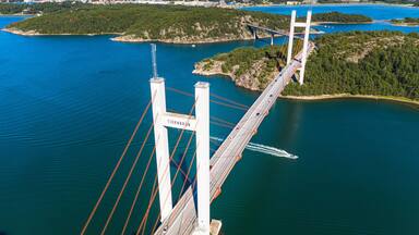 Panoramic aerial view of Tjörnbron suspension bridge with passing cars, Stenungsund, Sweden, Scandinavia.